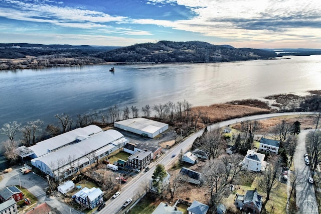 aerial view at dusk featuring a water view