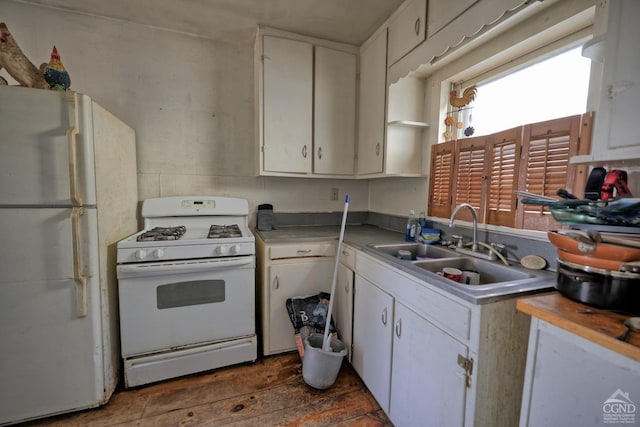 kitchen with dark hardwood / wood-style floors, white cabinetry, white appliances, and sink