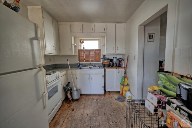 kitchen with white cabinets, sink, white appliances, and dark wood-type flooring