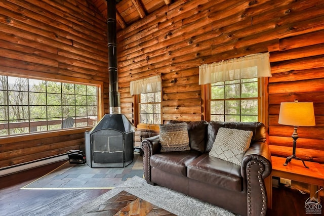 living room with a wood stove, plenty of natural light, wood-type flooring, and a high ceiling