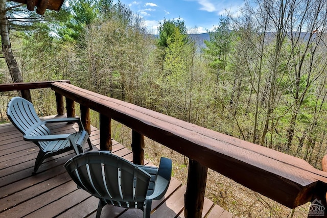wooden terrace with a wooded view