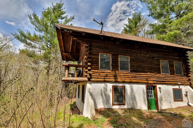 rear view of property featuring log siding