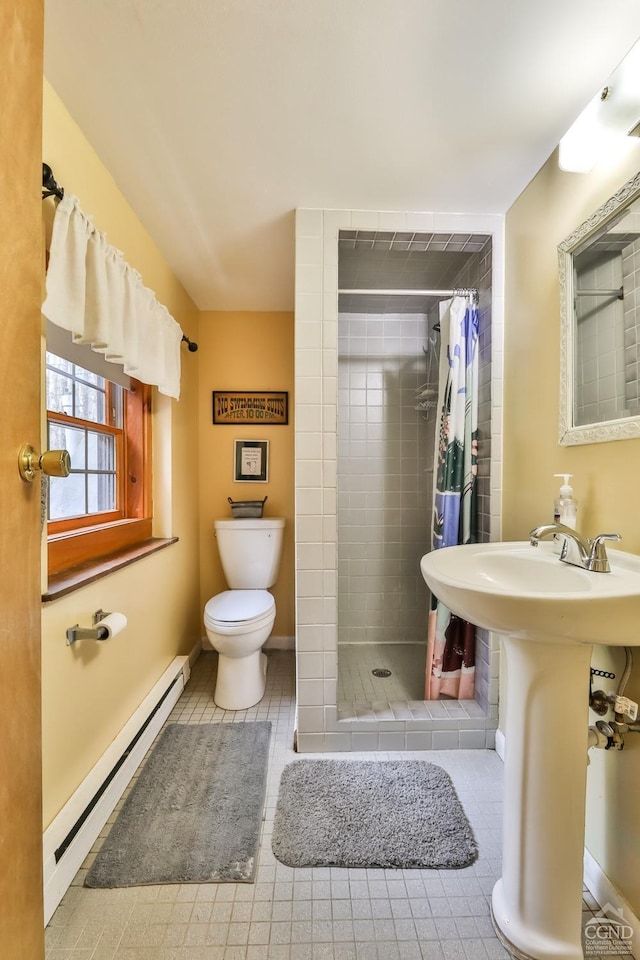 bathroom with a stall shower, a baseboard radiator, toilet, and tile patterned floors