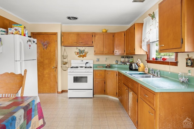 kitchen with crown molding, white appliances, and sink