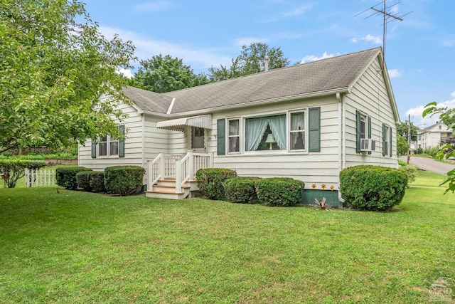 view of front of property featuring cooling unit and a front lawn