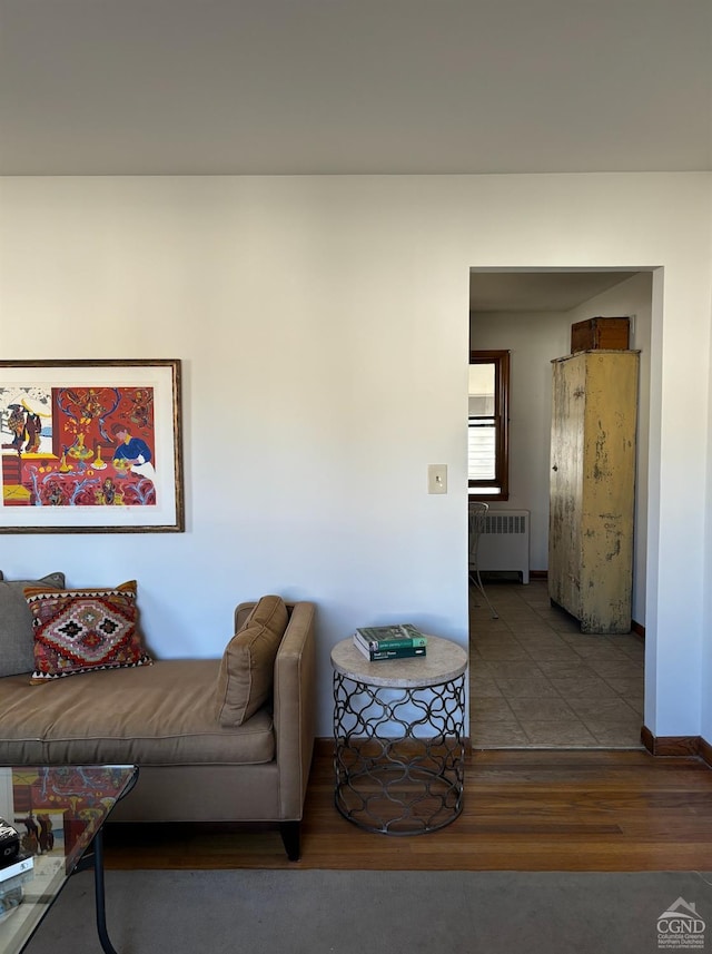 living room with hardwood / wood-style floors and radiator heating unit