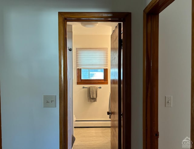 hallway featuring light hardwood / wood-style floors and baseboard heating