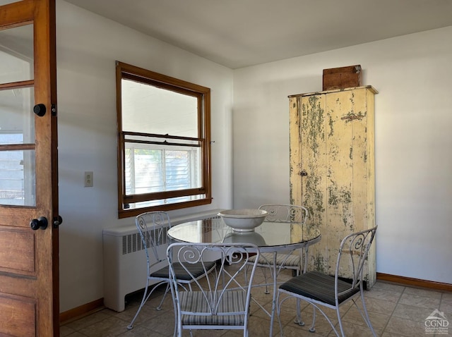 dining space with a wealth of natural light and light tile patterned flooring