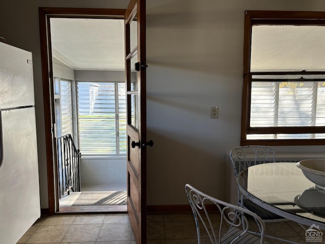 entryway with light tile patterned flooring