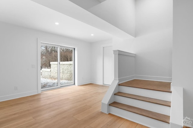 stairway with hardwood / wood-style flooring