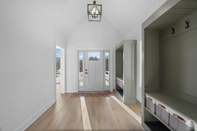 mudroom featuring high vaulted ceiling and light hardwood / wood-style floors