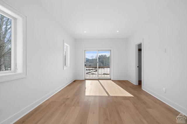 spare room with light hardwood / wood-style floors