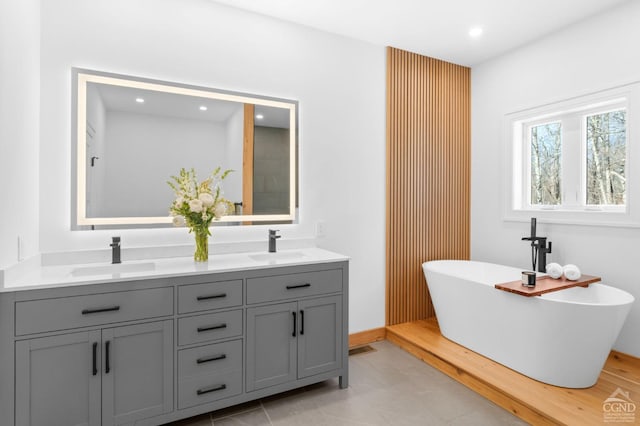 bathroom featuring vanity and a bath