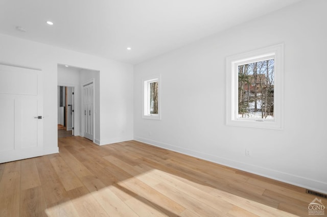 spare room featuring light hardwood / wood-style flooring