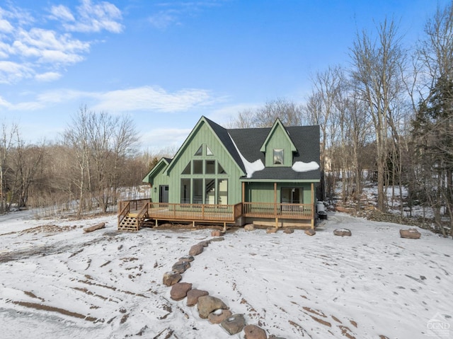 snow covered property featuring a deck