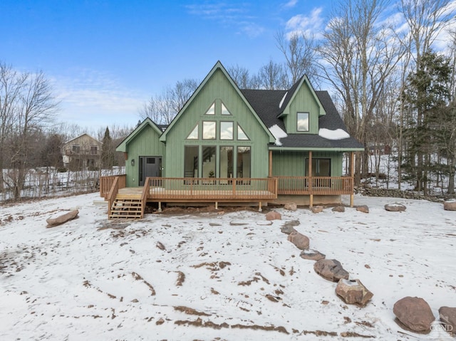 snow covered property with a wooden deck