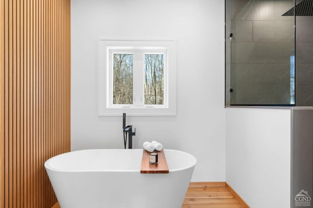 bathroom featuring hardwood / wood-style flooring and independent shower and bath