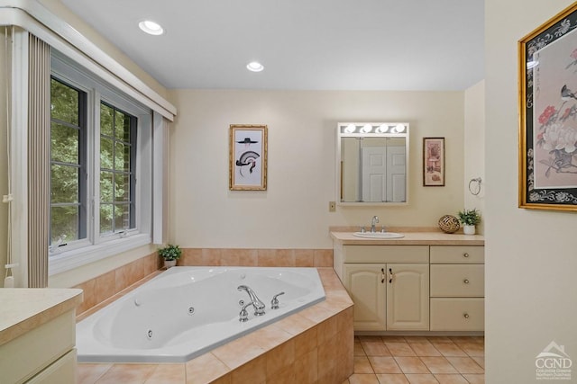 bathroom featuring tile patterned floors, vanity, and tiled bath