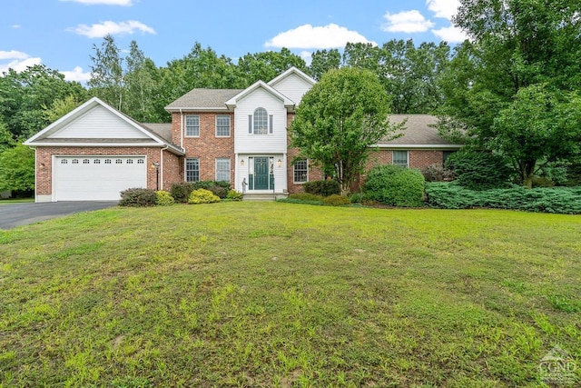 view of front of home with a front yard and a garage