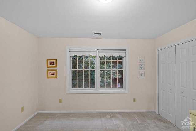 unfurnished room with light carpet