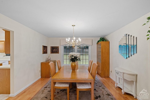 dining space featuring light hardwood / wood-style floors and a notable chandelier