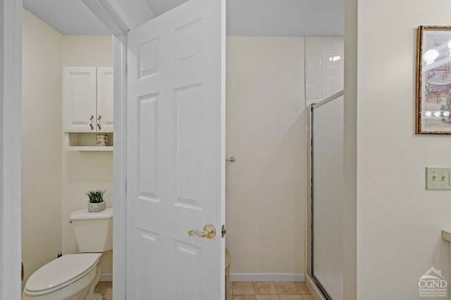 bathroom featuring tile patterned floors, an enclosed shower, and toilet