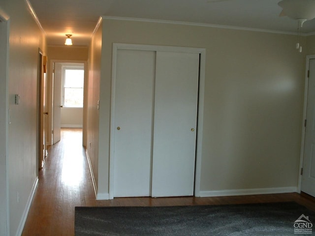 interior space featuring crown molding, a closet, and light hardwood / wood-style floors