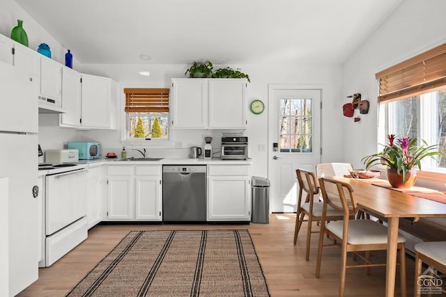 kitchen featuring white appliances, light wood-style flooring, a sink, under cabinet range hood, and white cabinetry
