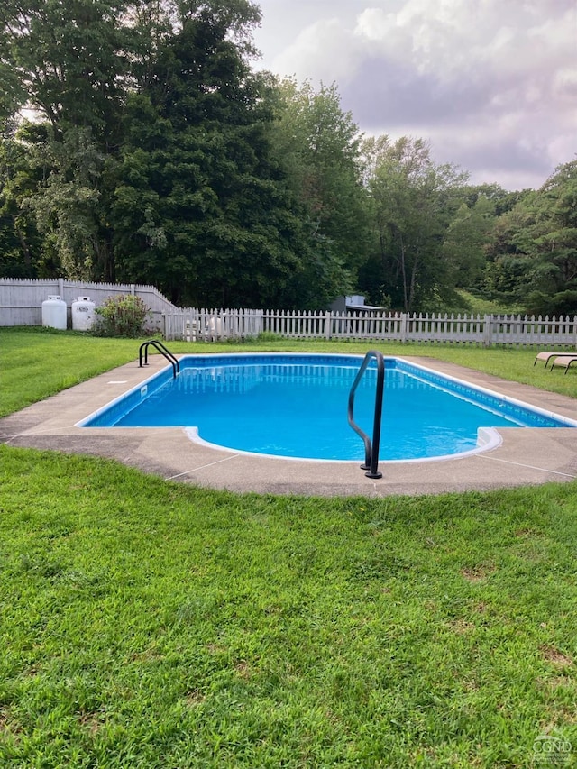 view of swimming pool featuring a lawn