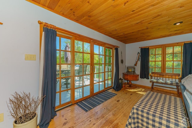 bedroom featuring multiple windows, wooden ceiling, and light hardwood / wood-style floors