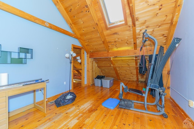 workout room with vaulted ceiling with skylight, wood ceiling, and hardwood / wood-style floors