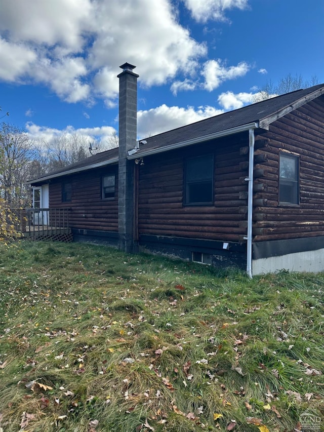 rear view of property with a lawn