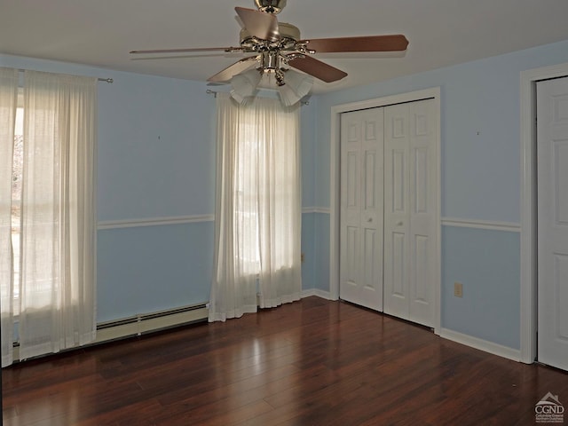 unfurnished bedroom with ceiling fan, dark wood-type flooring, and a closet