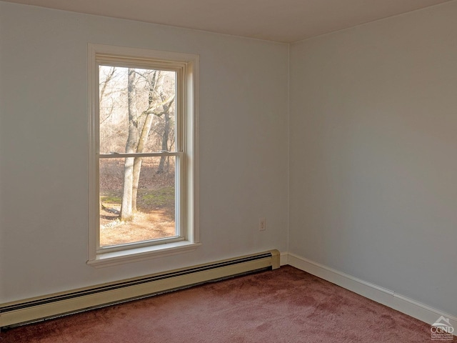 carpeted spare room with a baseboard heating unit