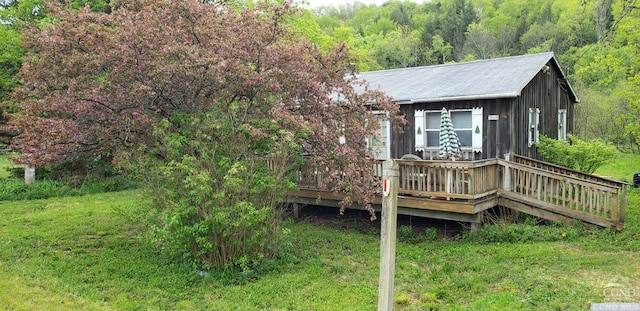 deck featuring an outbuilding and a yard