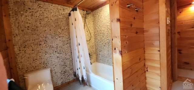 bathroom featuring wood walls, toilet, wooden ceiling, and shower / tub combo with curtain