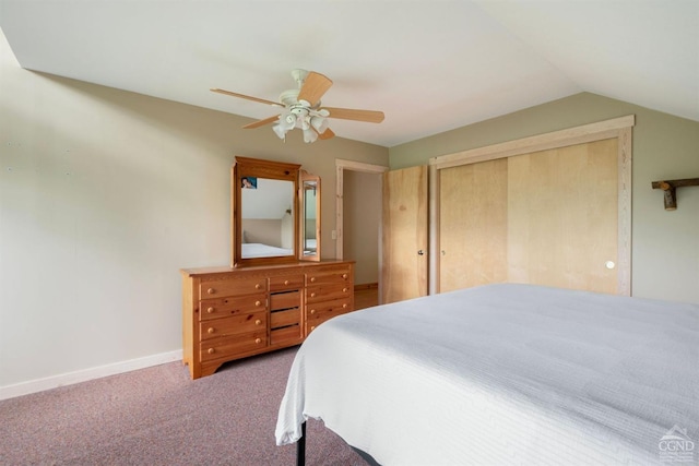 carpeted bedroom with ceiling fan, lofted ceiling, and a closet