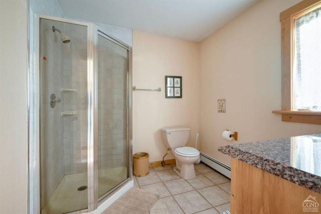 bathroom featuring tile patterned floors, toilet, a shower with door, and a baseboard heating unit