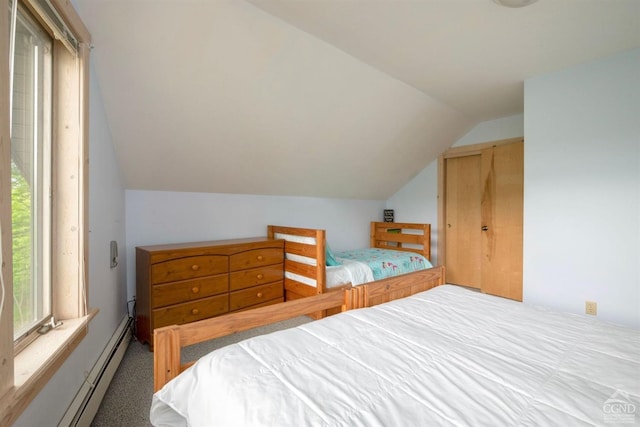 carpeted bedroom with vaulted ceiling, multiple windows, a closet, and a baseboard heating unit