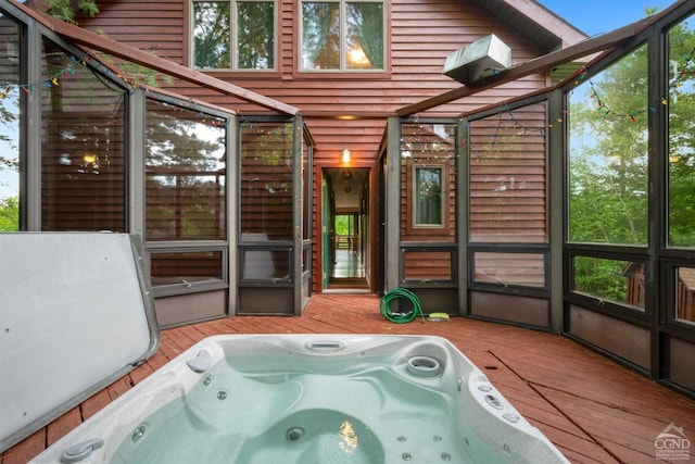 sunroom with a jacuzzi and a wealth of natural light