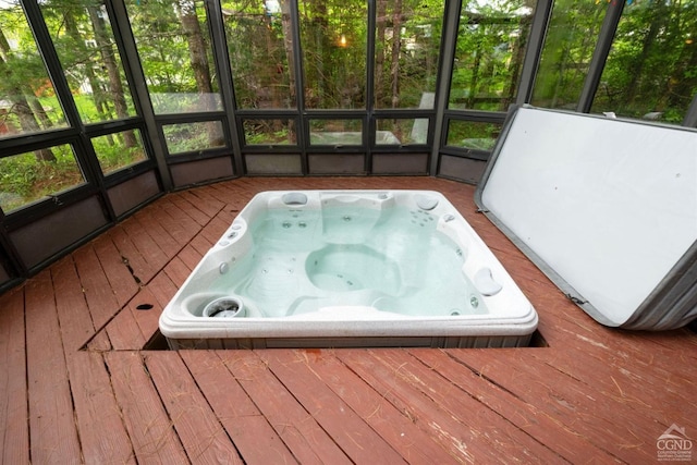 unfurnished sunroom featuring a jacuzzi