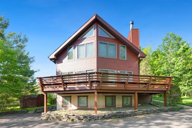 view of side of property featuring a wooden deck