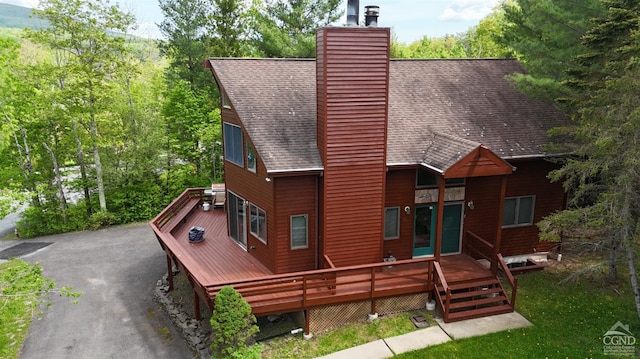 back of property with a wooden deck