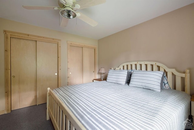 carpeted bedroom with two closets and ceiling fan