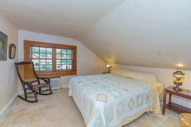 bedroom featuring a textured ceiling, lofted ceiling, and light carpet