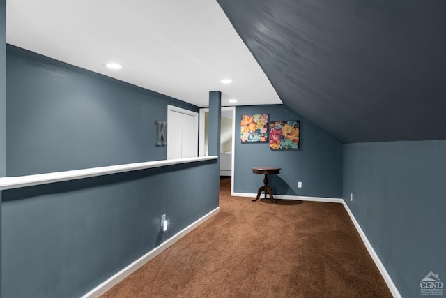 bonus room with carpet floors and vaulted ceiling