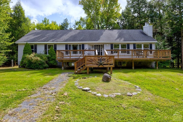 view of front facade with a front yard and a deck