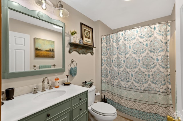 bathroom featuring vanity, toilet, and curtained shower