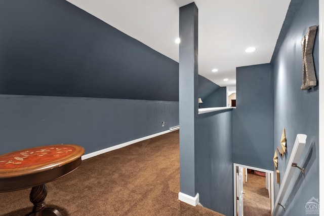 interior space featuring carpet flooring and vaulted ceiling