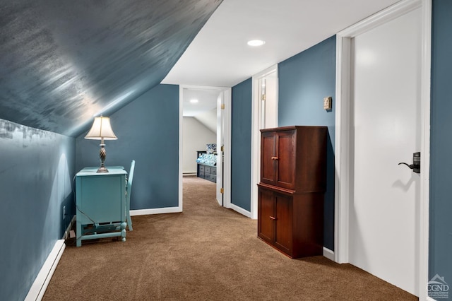 interior space featuring carpet flooring, a baseboard radiator, and lofted ceiling